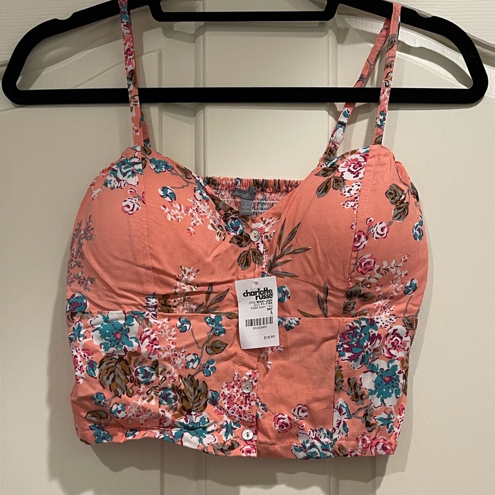 Peach and floral bustier top with ruched back and adjustable straps.